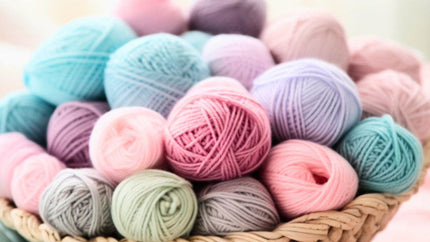 Basket of colorful yarn balls in various shades.